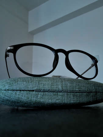 Stylish glasses for men and women on a grey wooden table.の写真素材