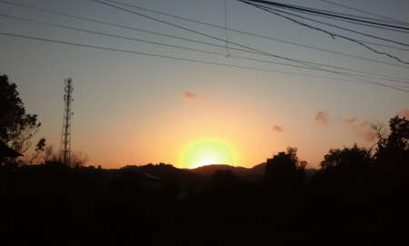The sun rises this time unlike usual, the color of the orange this time is very subtle and does not scatter anywhere, it coils the main core of the sun.の写真素材