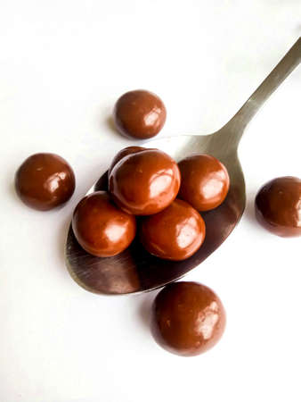 Chocolate that is more than one grain, is being placed on a spoon and is suitable to eat when snacking with familyの写真素材
