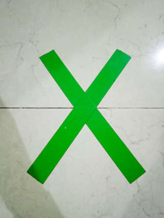 A cross, its function is to keep a distance from other people, so that they are not close together and can cause the spread of the coronavirusの写真素材