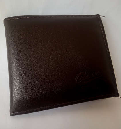 The leather wallet that I use to store money or ATM cards and others, this wallet has a smooth texture and is comfortable when put in my pocket.の写真素材