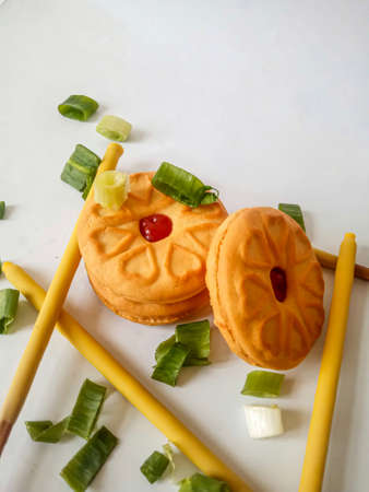 Yellow round biscuits, medium size, are decorated with green onions, these biscuits are perfect for snacking with family.の写真素材