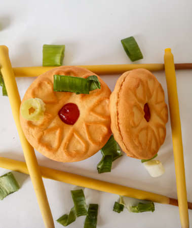 Yellow round biscuits, medium size, are decorated with green onions, these biscuits are perfect for snacking with family.の写真素材