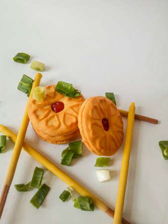 Yellow round biscuits, medium size, are decorated with green onions, these biscuits are perfect for snacking with family.の写真素材