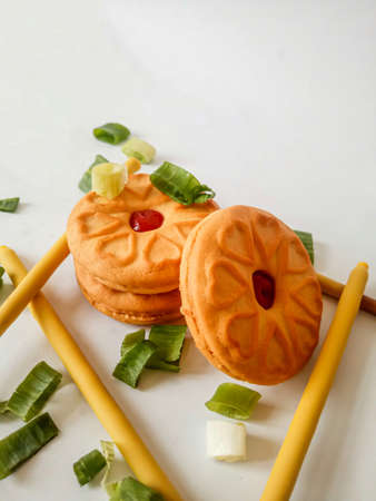 Yellow round biscuits, medium size, are decorated with green onions, these biscuits are perfect for snacking with family.の写真素材