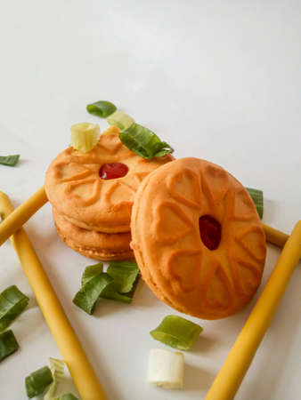 Yellow round biscuits, medium size, are decorated with green onions, these biscuits are perfect for snacking with family.の写真素材