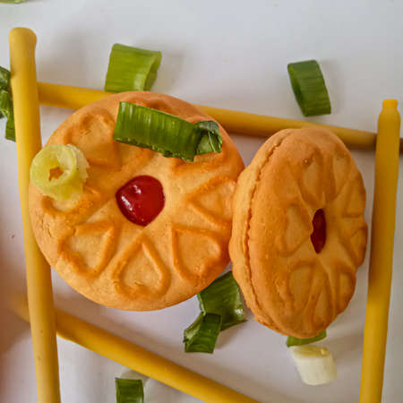 Yellow round biscuits, medium size, are decorated with green onions, these biscuits are perfect for snacking with family.の写真素材