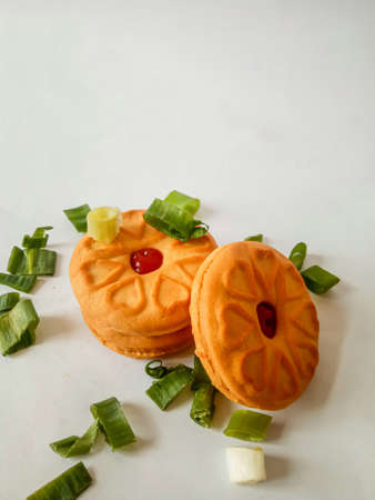 Yellow round biscuits, medium size, are decorated with green onions, these biscuits are perfect for snacking with family.の写真素材