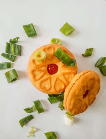 Yellow round biscuits, medium size, are decorated with green onions, these biscuits are perfect for snacking with family.の写真素材
