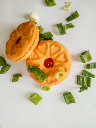Yellow round biscuits, medium size, are decorated with green onions, these biscuits are perfect for snacking with family.の写真素材