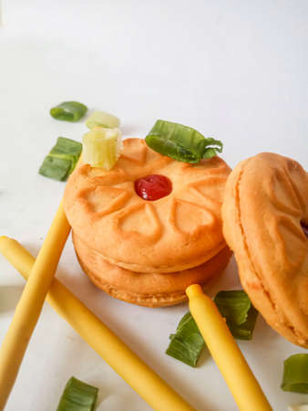 Yellow round biscuits, medium size, are decorated with green onions, these biscuits are perfect for snacking with family.の写真素材