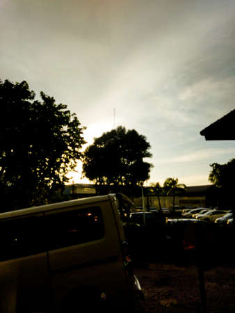 The sun rises in the morning is seen from the car park in the apartmentの写真素材