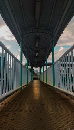 The bridge leads to the trans-Jakarta bus ride, crossing the busy and dense highway.の写真素材