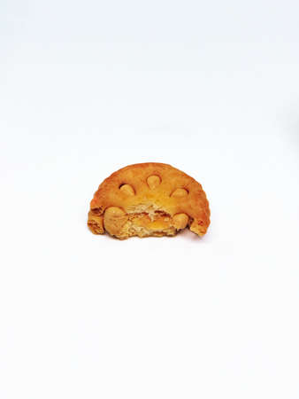 Medium orange round coconut biscuits are being served on the table, these biscuits are perfect for snacking with tea with the familyの写真素材
