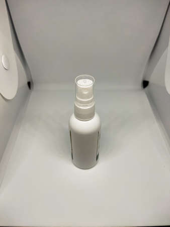 A white plastic bottle, how to use this bottle, by spraying it, the liquid that comes out of this bottle can be used to clean eyeglass lenses, or gadget screens, which are dirty or dusty.の写真素材