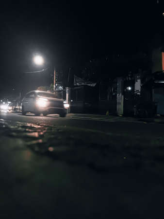 Night streets in Jakarta Indonesia, are full of 2 and 4 wheeled vehicles such as cars and motorbikes.の写真素材