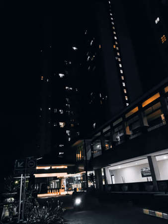 The apartment building at night, with bright lightsの写真素材