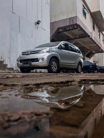 Reflection on the water from the car parked beside the buildingのeditorial素材