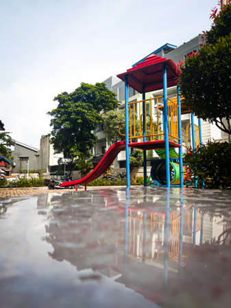 A playground for children to play, located in an apartment gardenの写真素材