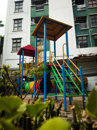 A playground for children to play, located in an apartment gardenの写真素材