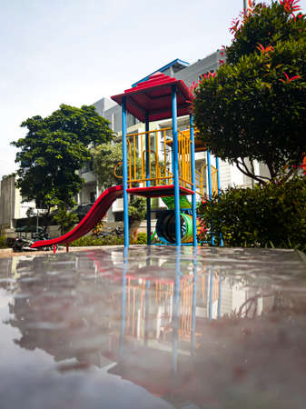 A playground for children to play, located in an apartment gardenの写真素材
