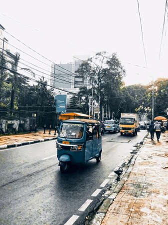 Jakarta Pusat, Indonesia, February 16th, 2021: public transportation carriages passing rapidly on the highway in the afternoon, while carrying passengers to their destinationのeditorial素材