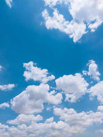 Sunny weather is accompanied by clean white clouds in a beautiful blue sky.の写真素材