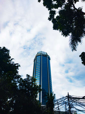 Central Jakarta, Indonesia - March 12th, 2021: Mandiri bank building has an oval shape like a tower.