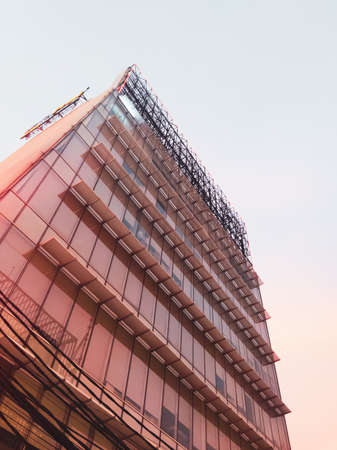 A building exposed to the orange glow of the sunsetの写真素材