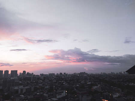 The sun was setting, it was orange and it looked absolutely stunning. immersed behind tall buildings in Jakarta Indonesiaの写真素材