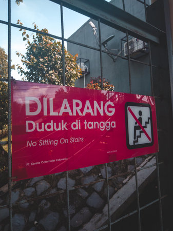 The sign prohibiting sitting on the stairs, made by Indonesian KRL at the station, so as not to...