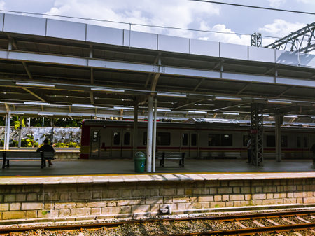 Central Jakarta, Indonesia - April 5th, 2021: People are waiting for the train at the station during the day, to go to its destination.のeditorial素材