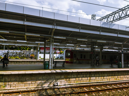 Central Jakarta, Indonesia - April 5th, 2021: People are waiting for the train at the station during the day, to go to its destination.のeditorial素材