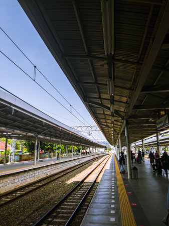 Central Jakarta, Indonesia - April 5th, 2021: People are waiting for the train at the station during the day, to go to its destination.のeditorial素材