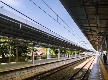 Central Jakarta, Indonesia - April 5th, 2021: People are waiting for the train at the station during the day, to go to its destination.のeditorial素材