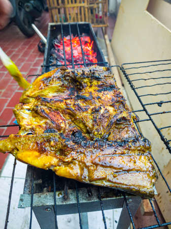 Fish that looks delicious when grilled over coconut shells until golden brown or until cooked.の写真素材