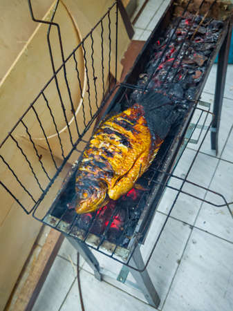 Fish that looks delicious when grilled over coconut shells until golden brown or until cooked.の写真素材