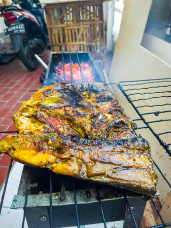 Fish that looks delicious when grilled over coconut shells until golden brown or until cooked.の写真素材