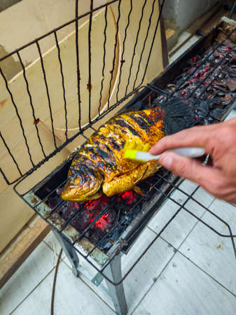 Fish that looks delicious when grilled over coconut shells until golden brown or until cooked.の写真素材