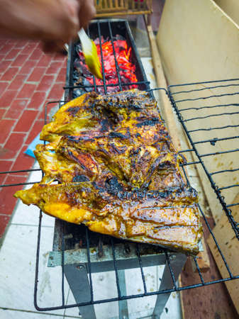 Fish that looks delicious when grilled over coconut shells until golden brown or until cooked.の写真素材