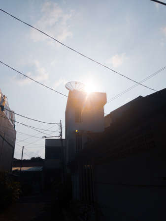 The beauty of the sky and the sun in the hallway of the residents' housesの写真素材