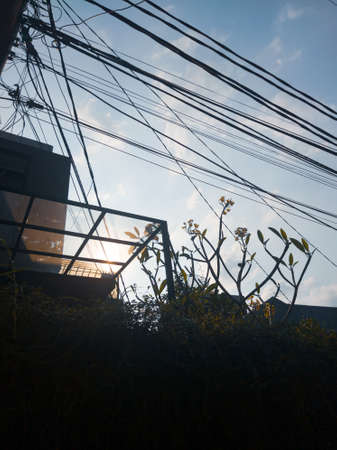 Blue sky and beautiful sun between the wiresの写真素材