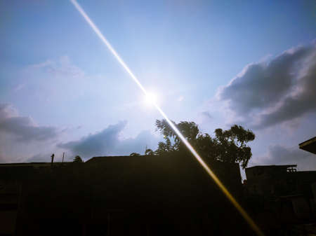 The blue sky and the sun are very dazzling touching the eyesの写真素材