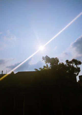 The blue sky and the sun are very dazzling touching the eyesの写真素材