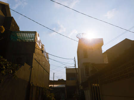The beauty of the sky and the sun in the hallway of the residents' housesの写真素材