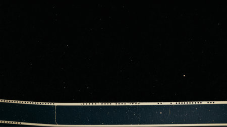 Blank film strip texture with grain and light leak.の素材