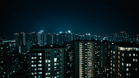 Urban nightscape with illuminated city skyline and skyscrapers.の素材