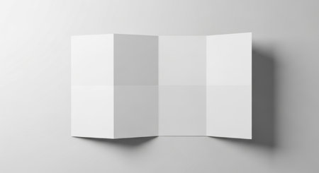 Minimalist folded blank paper mockup on a clean gray background.の素材