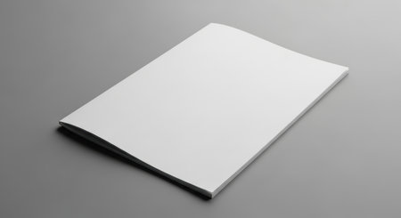 Blank white magazine mockup on a neutral gray background for branding and design.の素材