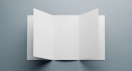 Blank folded brochure on minimalist gray background for design mockup and branding.の素材